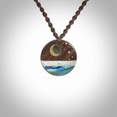 This photo shows a disc pendant hand carved from Lignum Vitae with premium nz paua shell, Mother of Pearl alongside; brass, copper and silver. This is a stand out one off necklace for those who appreciate art to wear. It is provided with a cord in brown that is a fixed length with Paua Shell Toggle. We ship this piece worldwide and shipping is included in the price.